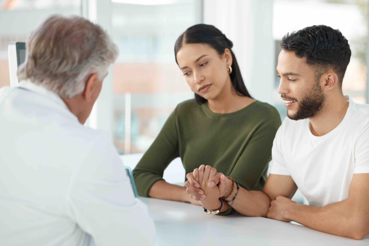 A Comprehensive Guide to Fertility Treatment Options Young couple sits with obstetrician during a fertility consultation in the clinic