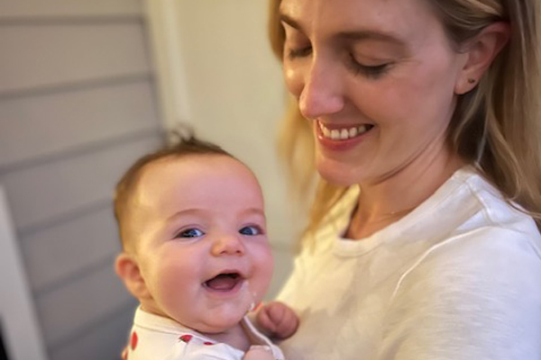 5 Breastfeeding Questions Answered: From Benefits and Challenges to Pumping Advice Dr. Sager smiling at her daughter after breastfeeding