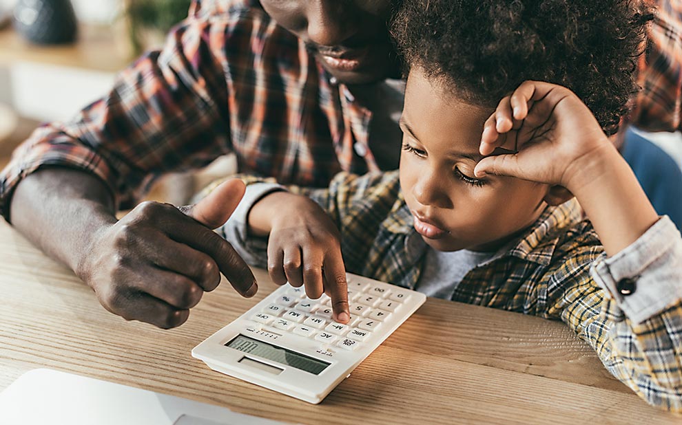 Kids, Cards, Currency, and Financial Literacy father and son with calculator