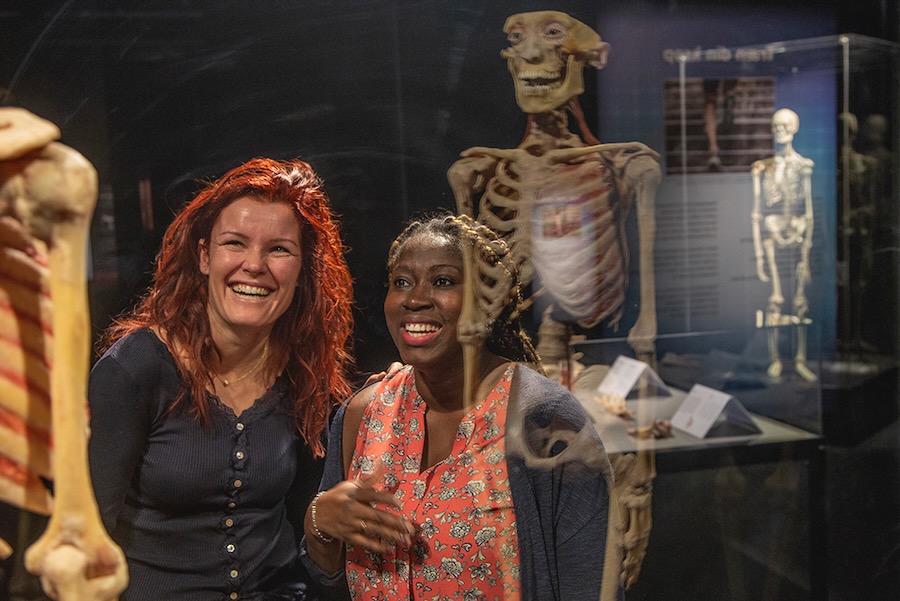 Summer Exhibit at the Science Museum of Virginia Spotlights a Different Perspective of Happiness two adults at Body Worlds exhibit