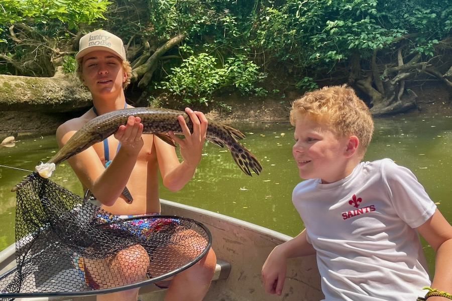 Old Engine, New Spark boys fishing in boat