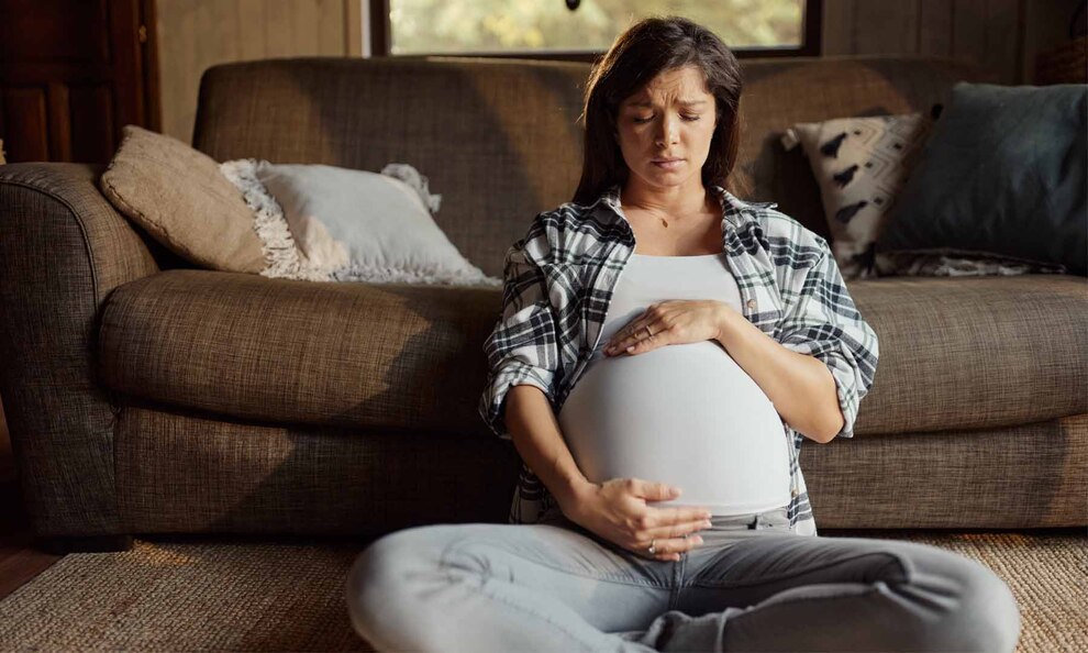 Signs of Preterm Labor: Symptoms, Risks, and Prevention Tips A pregnant woman holds her belly