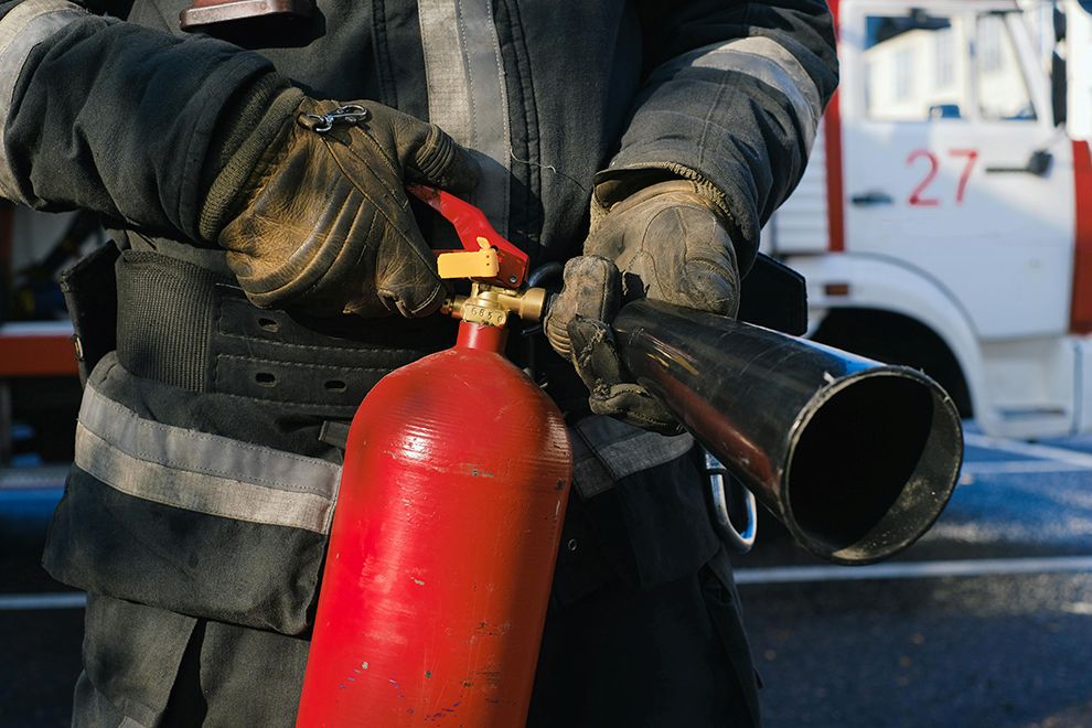 The Hidden Dangers of Lithium-Ion Batteries firefighter holding fire extinguisher