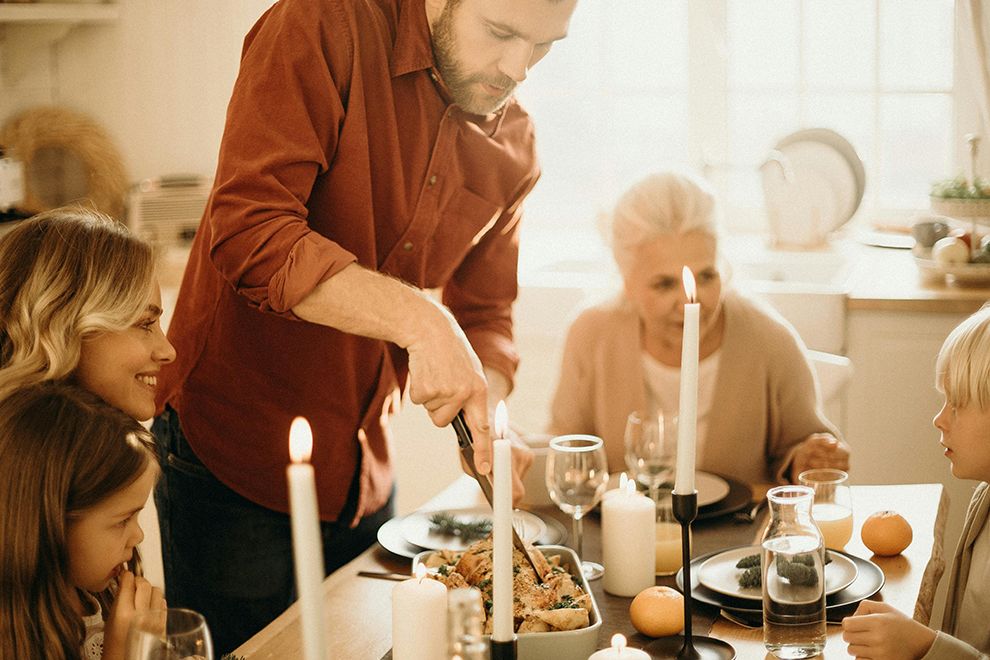 Hectic Holidays Multi-generational family eating dinner together