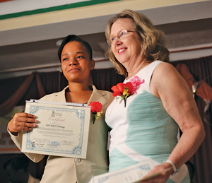 Nadene Brunk poses with a recent graduate who will serve as a skilled birth attendant in Haiti.